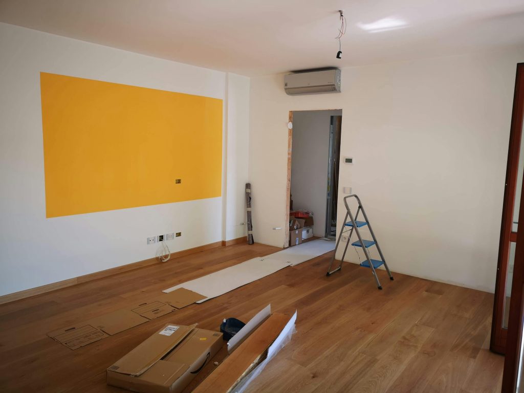 pexels photo 9908376 9908376 A bright, empty room under renovation with ladder, tools, and wooden flooring.